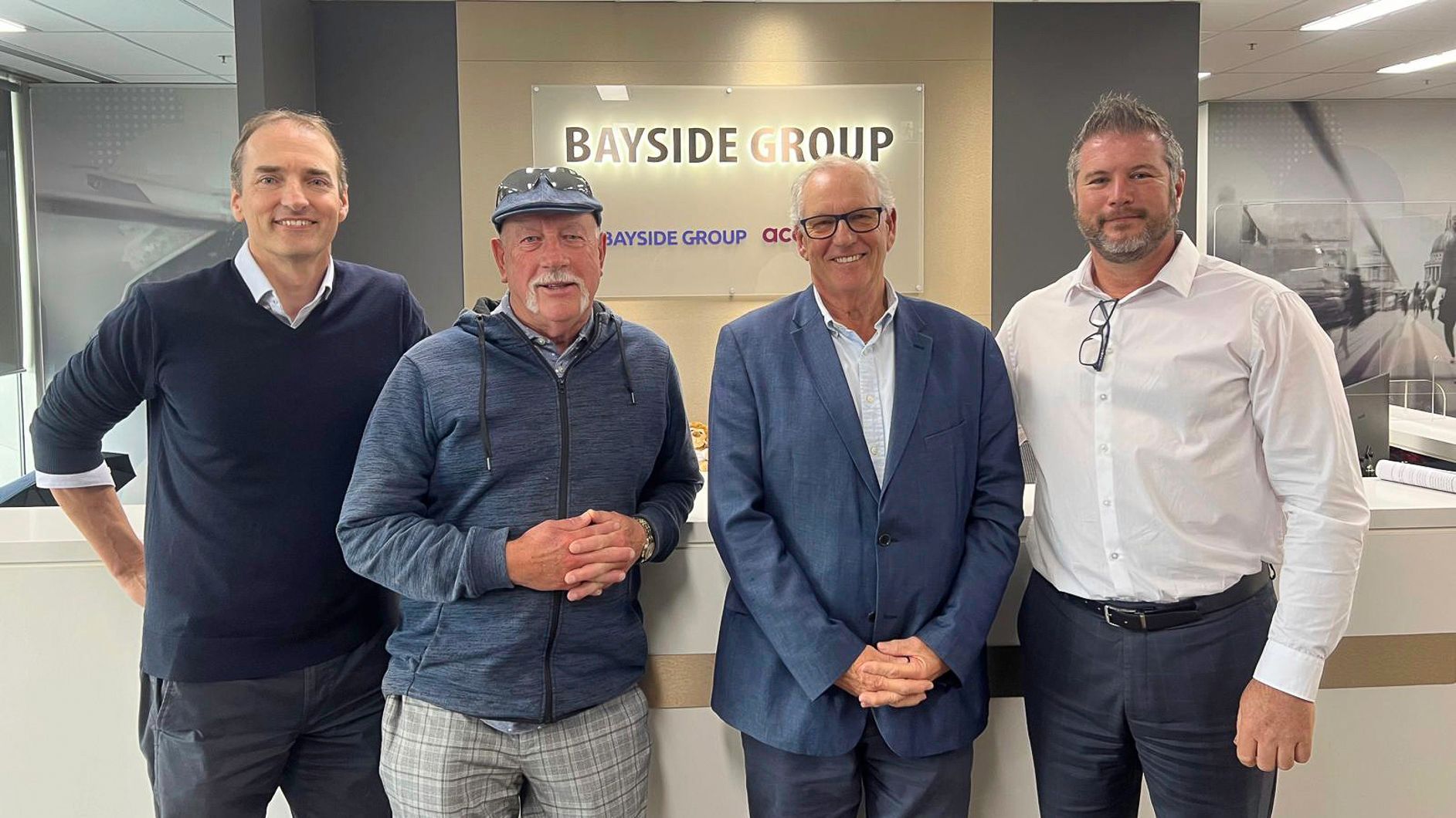 Wayne, Robert, John & Joe in front of the Bayside Group sign