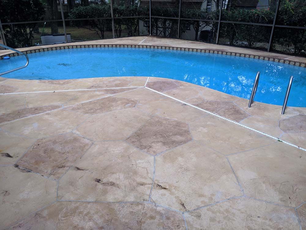 A large swimming pool with a fence around it