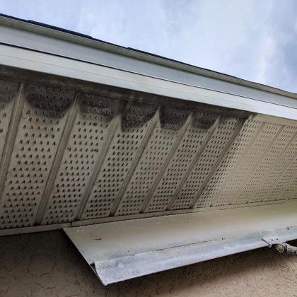 A close up of a roof with a gutter on it.