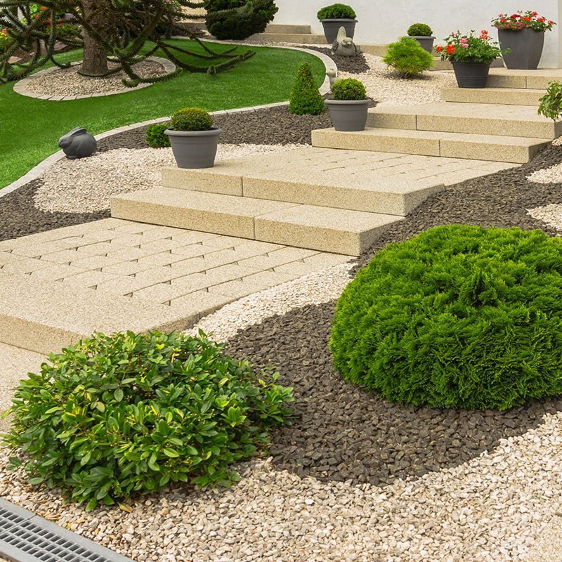 A garden with steps leading up to a house