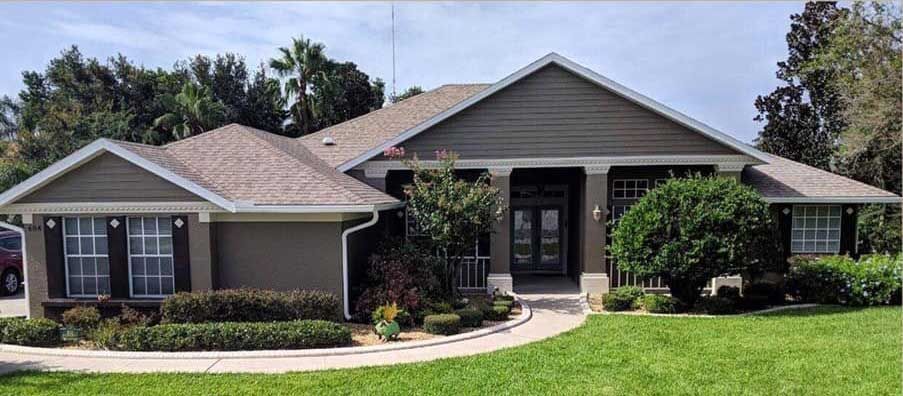 A large house with a lush green lawn in front of it