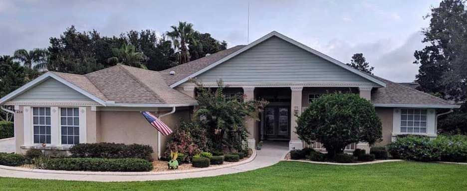A large house with a large lawn in front of it.