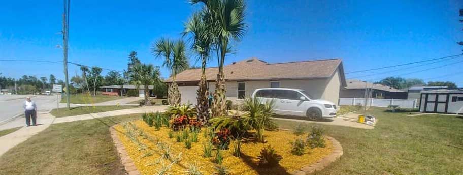 A white suv is parked in front of a house in a residential area.