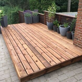 a new wooden decking area laid by Landscaping garden design Leicester