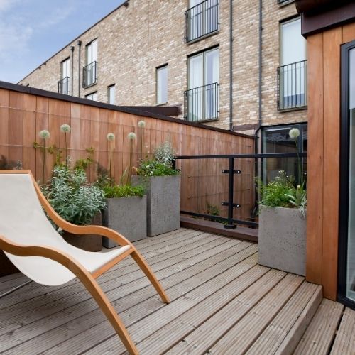 A picture of a Decking area with a sun lounger and plants in Leicester