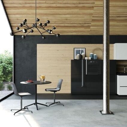 This is a picture of an outdoor room with a wooden ceiling and a Bistro table and chairs