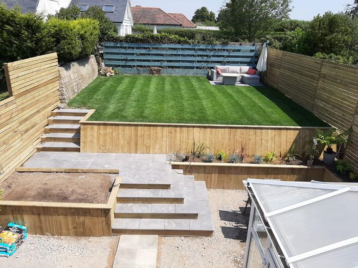 This is a picture of grey paving slabs in a garden
