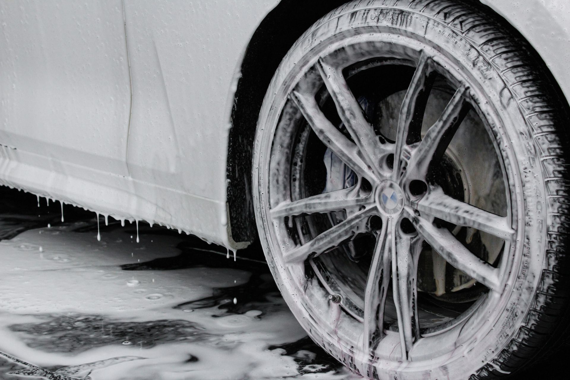 A close up of a car wheel covered in foam.