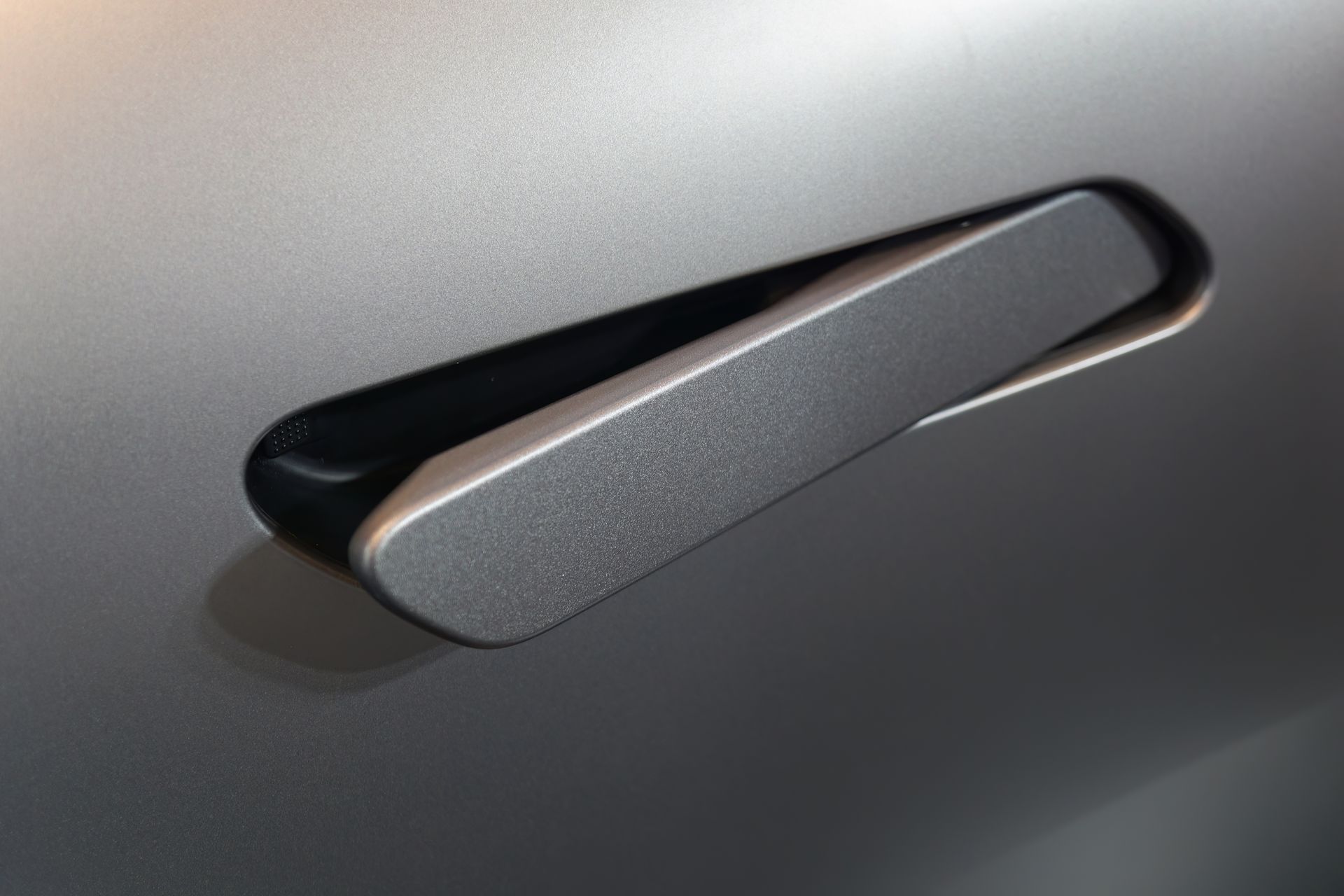 A close up of a door handle on a car.