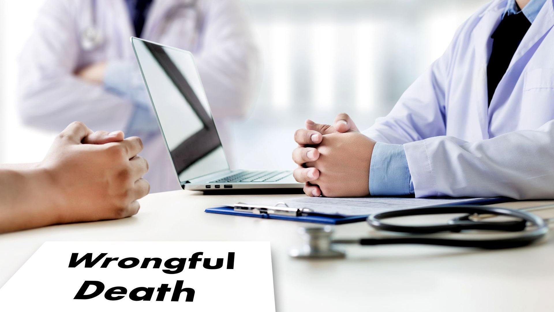 A doctor is sitting at a desk talking to a patient.