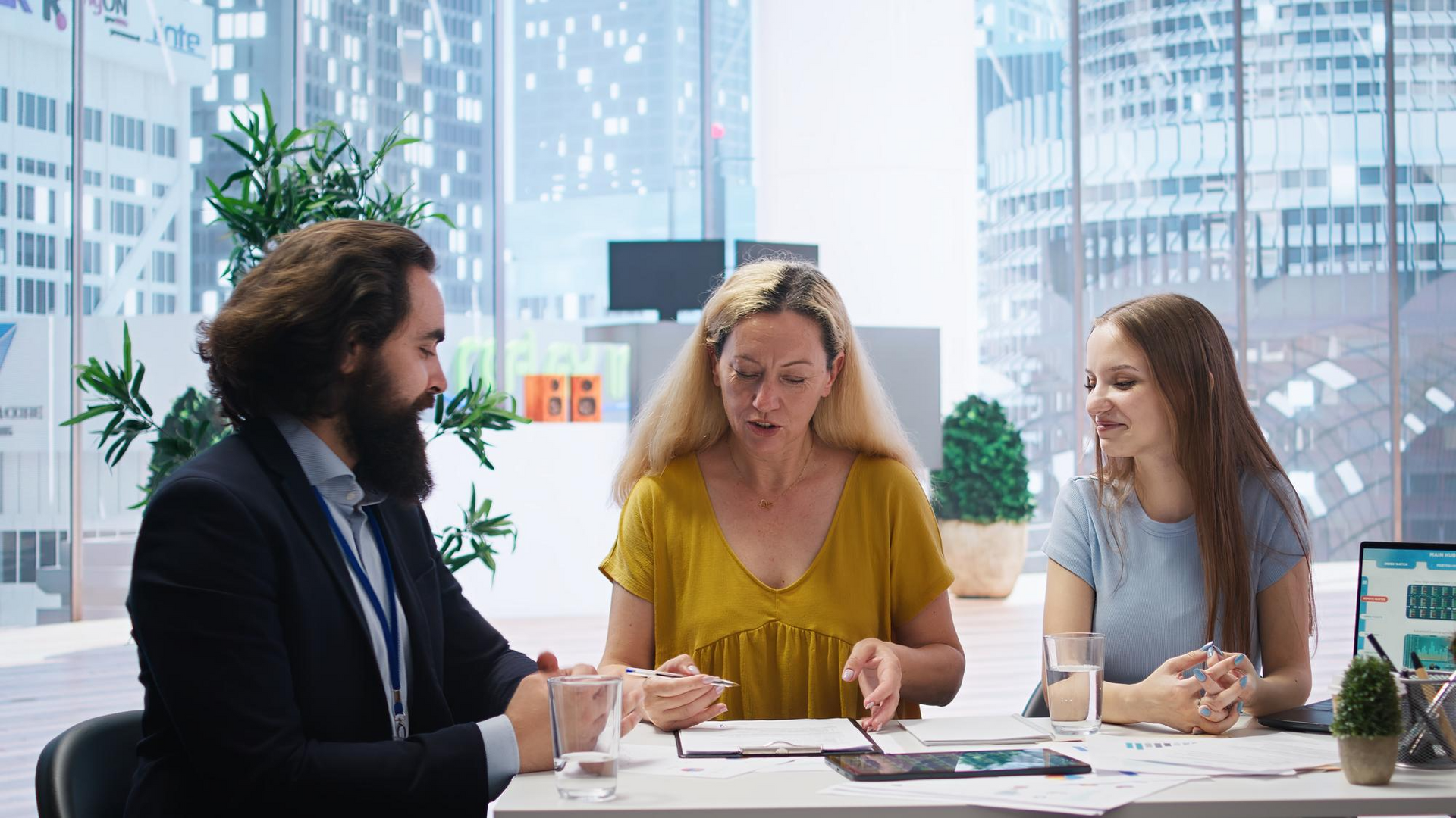 Business professionals collaborating in a modern office meeting, reviewing documents and discussing