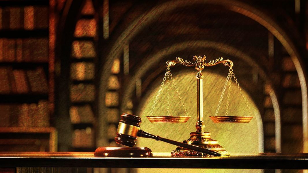 a judge 's gavel sits next to a scale of justice