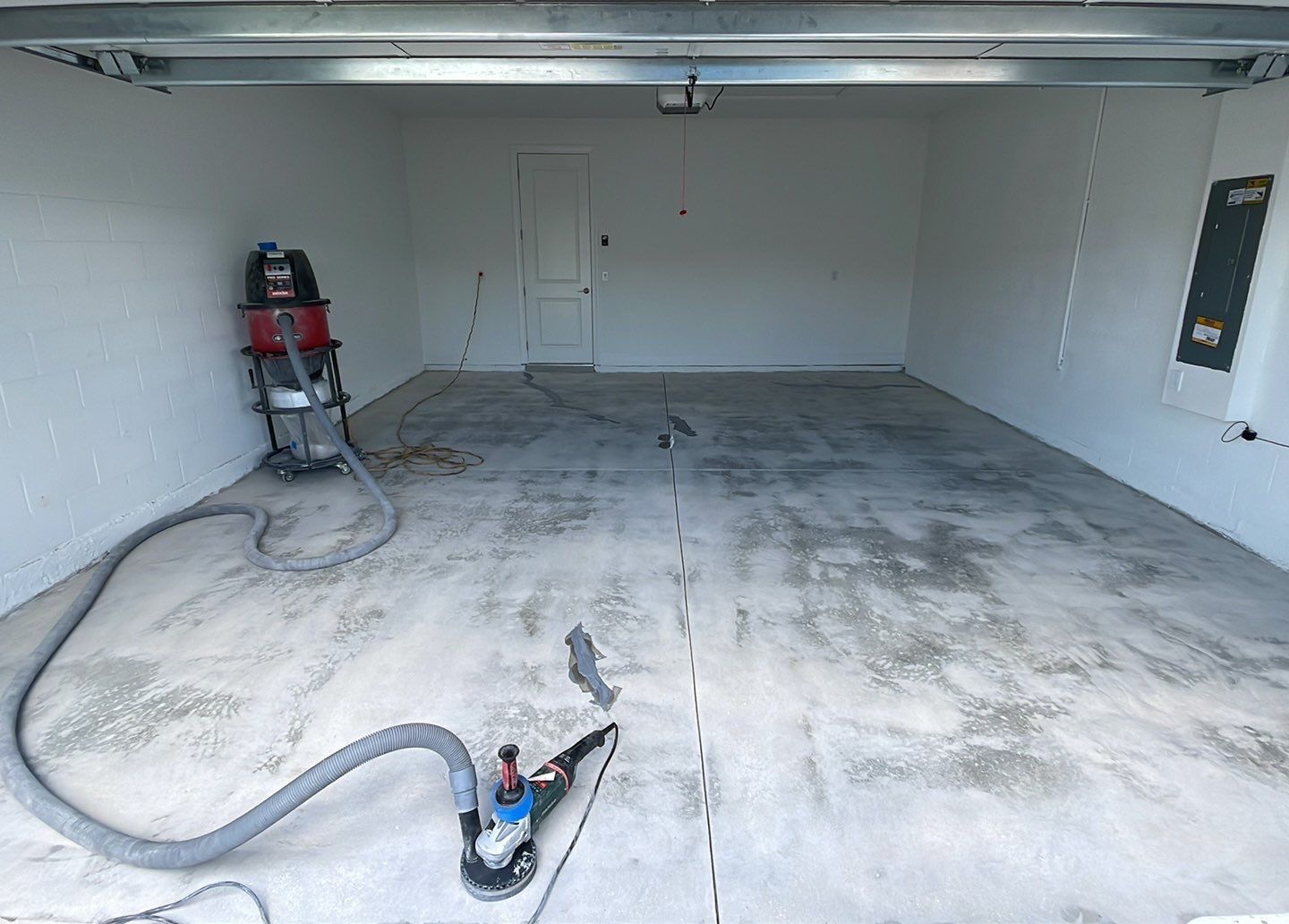 Interior of garage with concrete floor prepped by industrial grinder