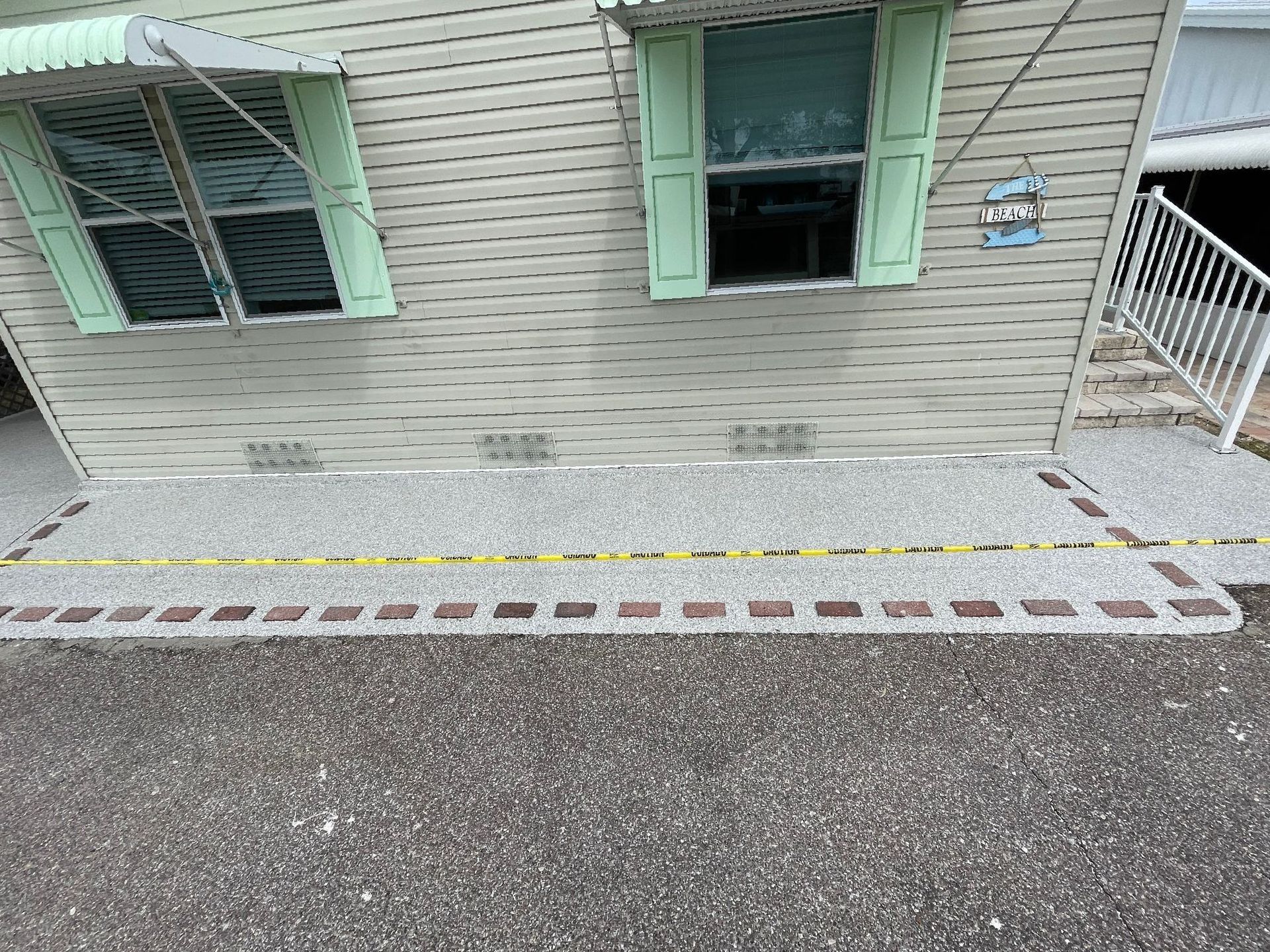 Concrete patio with inlaid brick after new concrete coating has been applied
