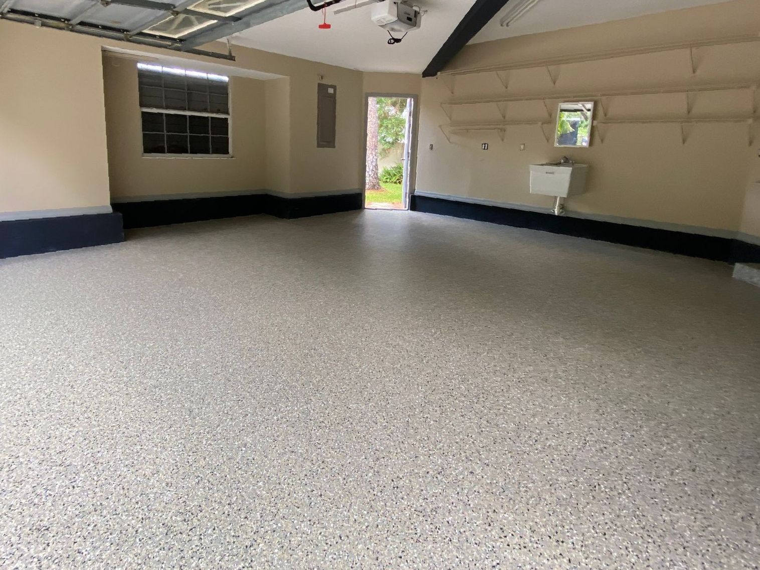 Garage with neutral-toned concrete coating applied to concrete floor
