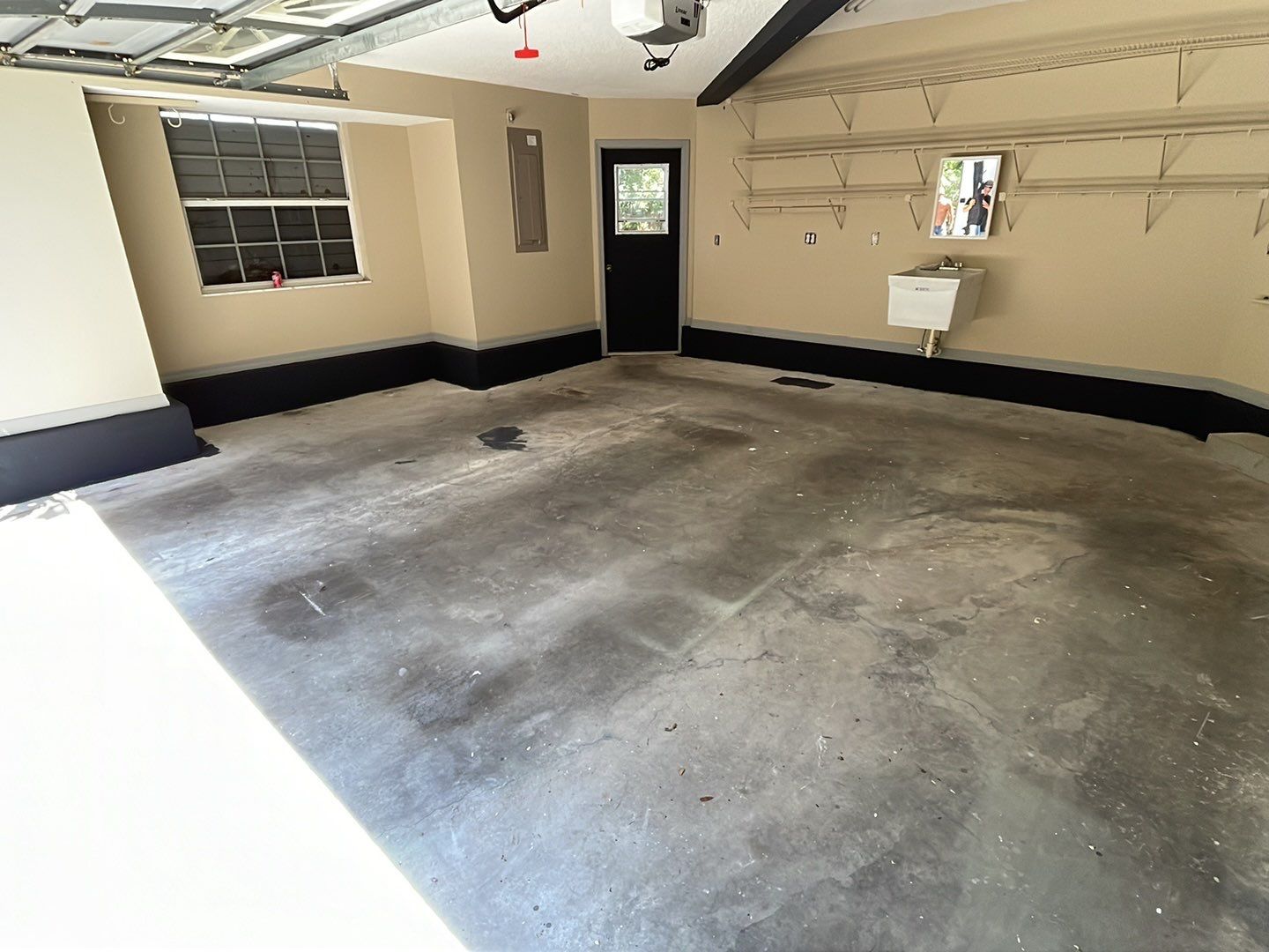 Garage with stained bare concrete floor