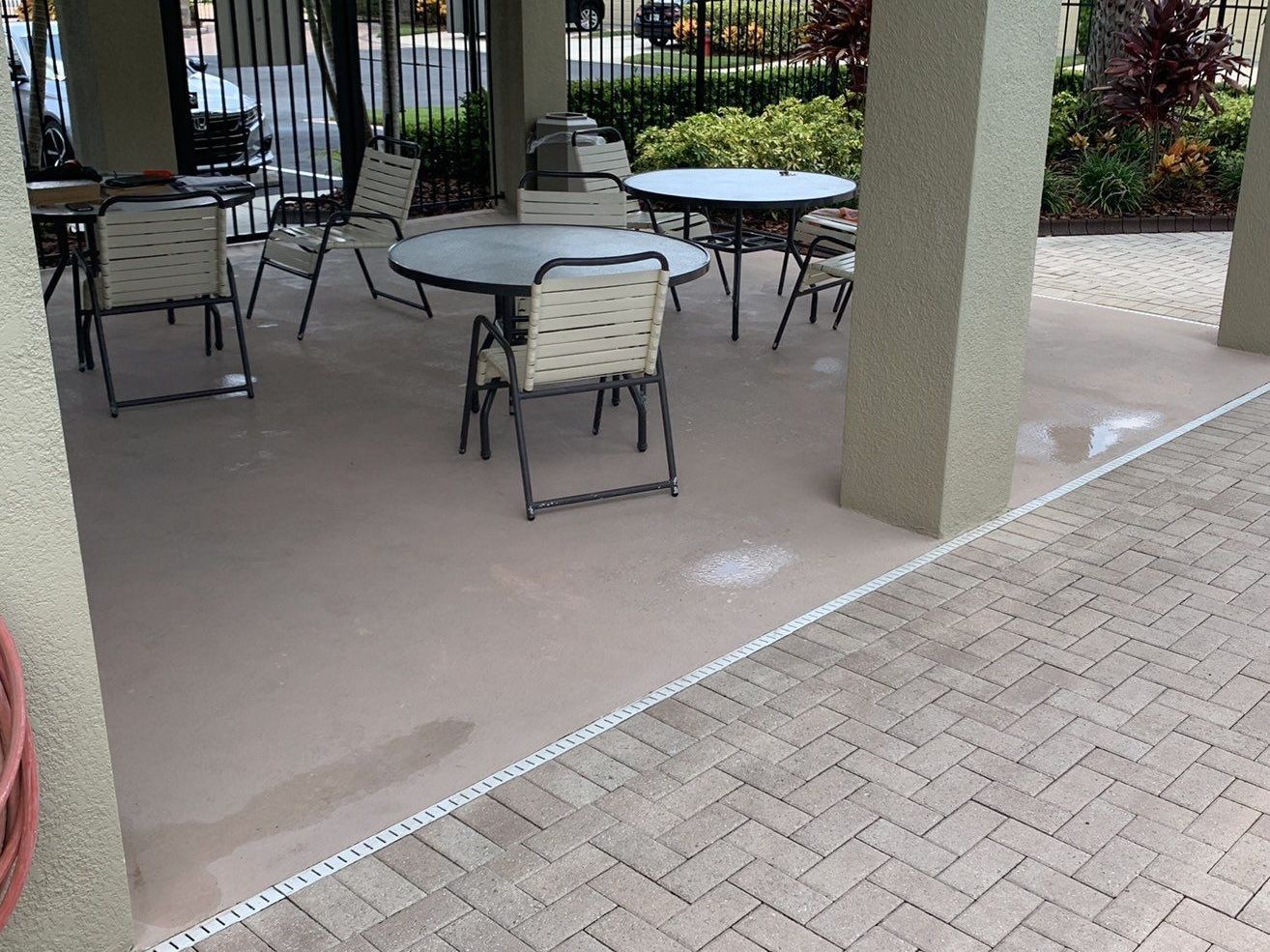 Cracked and stained concrete patio in condo pool area