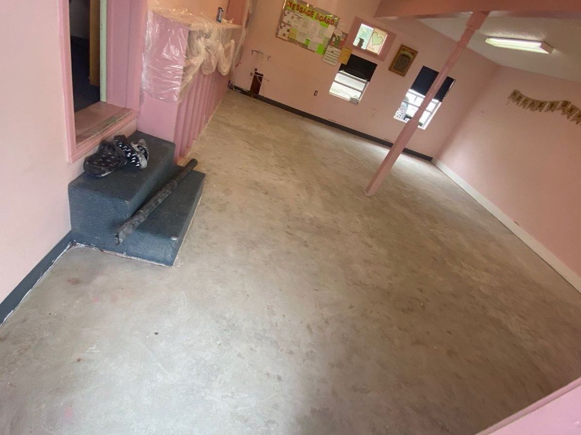 Room in childcare facility with bare concrete floor