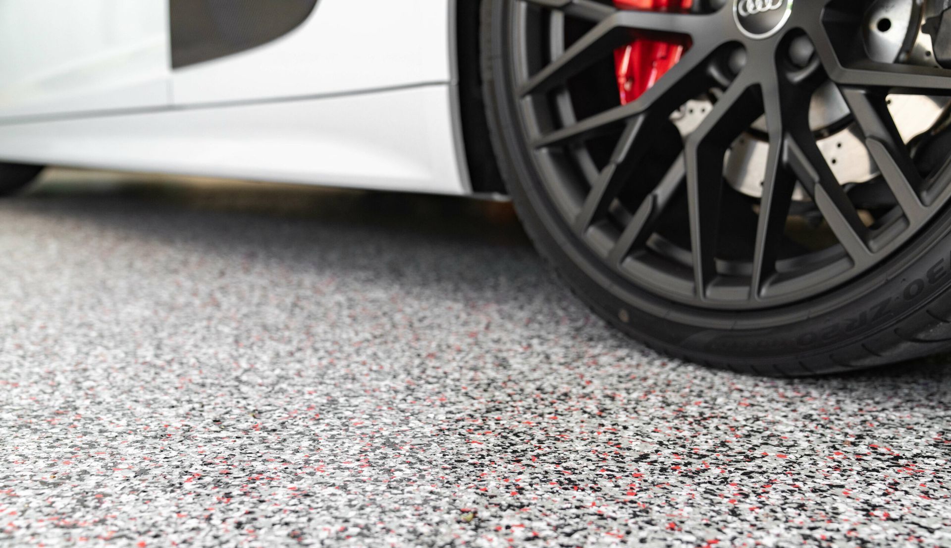 Sports car parked over luxury polyurea concrete coating