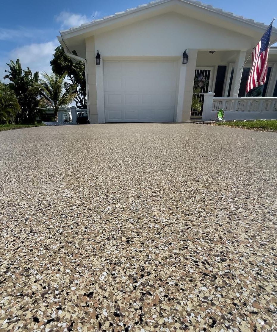 Freshly coated concrete driveway with a blend of brown and black flakes