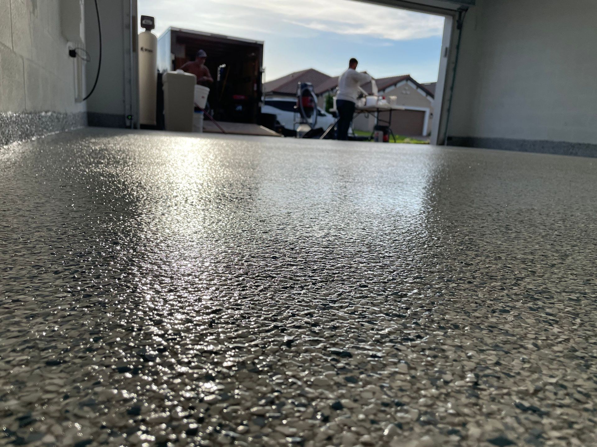 Close up of gleaming polyaspartic top coat on concrete garage floor