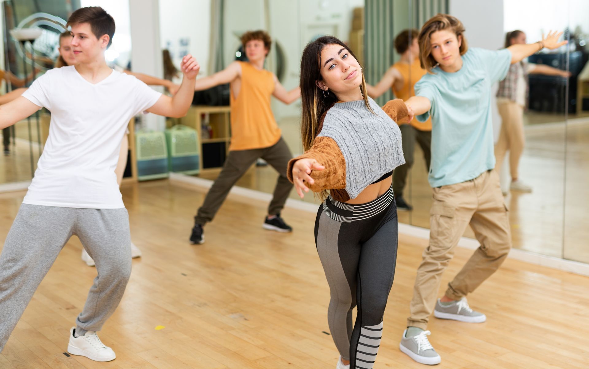 A group of young people are dancing in a dance studio.