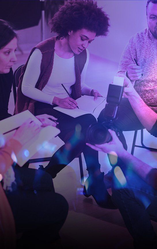 Praise fellowship church bible study group of people are sitting around a table writing in notebooks.