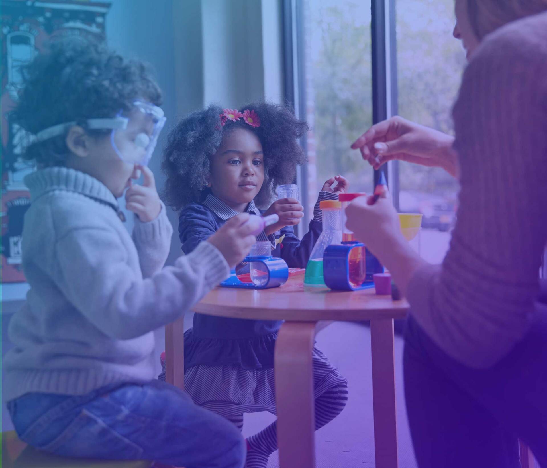 Praise fellowship church - a boy and a girl are sitting at a table playing with toys.