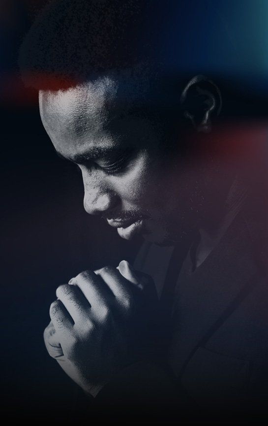Praise fellowship church - prayer night - a man praying with his hands folded.