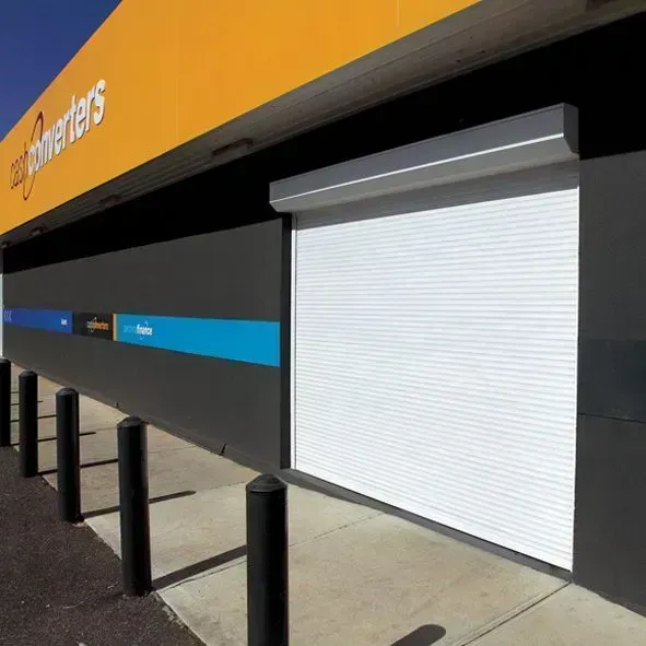 Exterior of a Cash Converters store with a closed white roller shutter. Black and yellow signage.