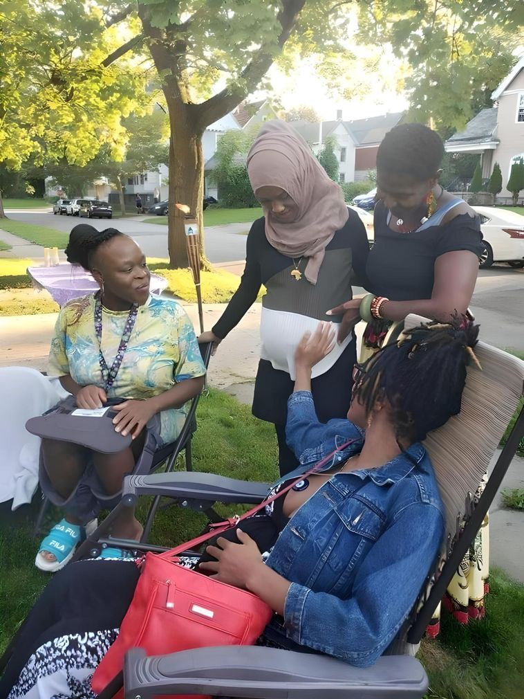 Image of several moms touching the baby bump of an expecting mom at an Our Mommie Village Meetup