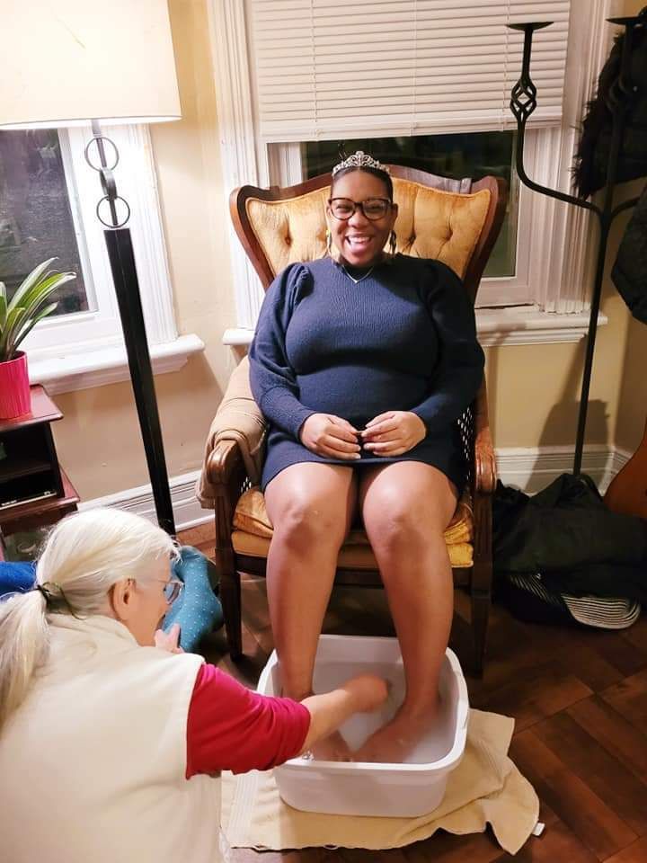 Image of Our Mommie Village mom at a meetup getting a foot soak