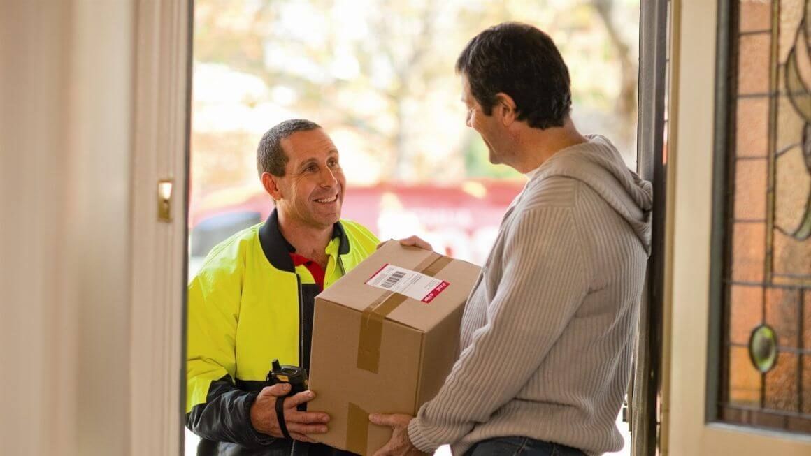 Man Hand Accepting A Delivery Boxes From Deliveryman At Home