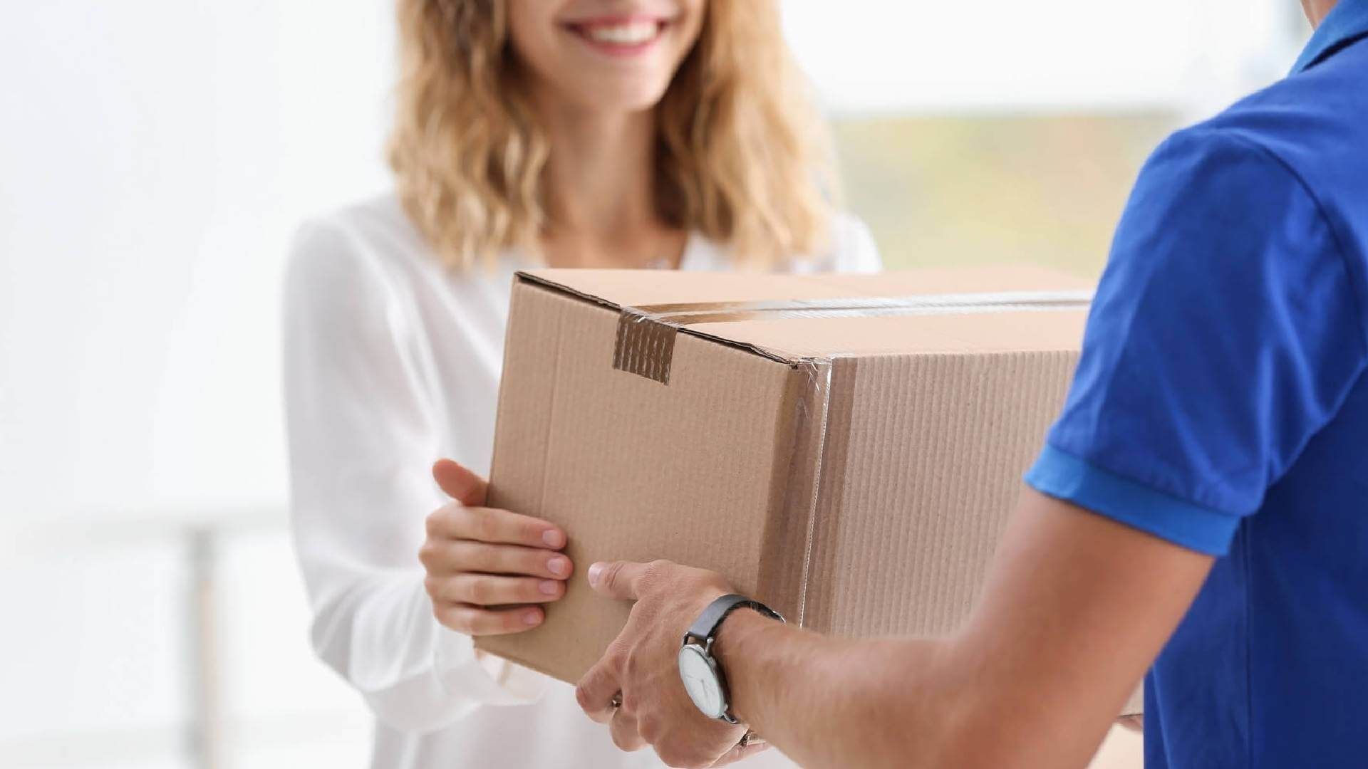 Man Hand Accepting A Delivery Boxes From Deliveryman At Home