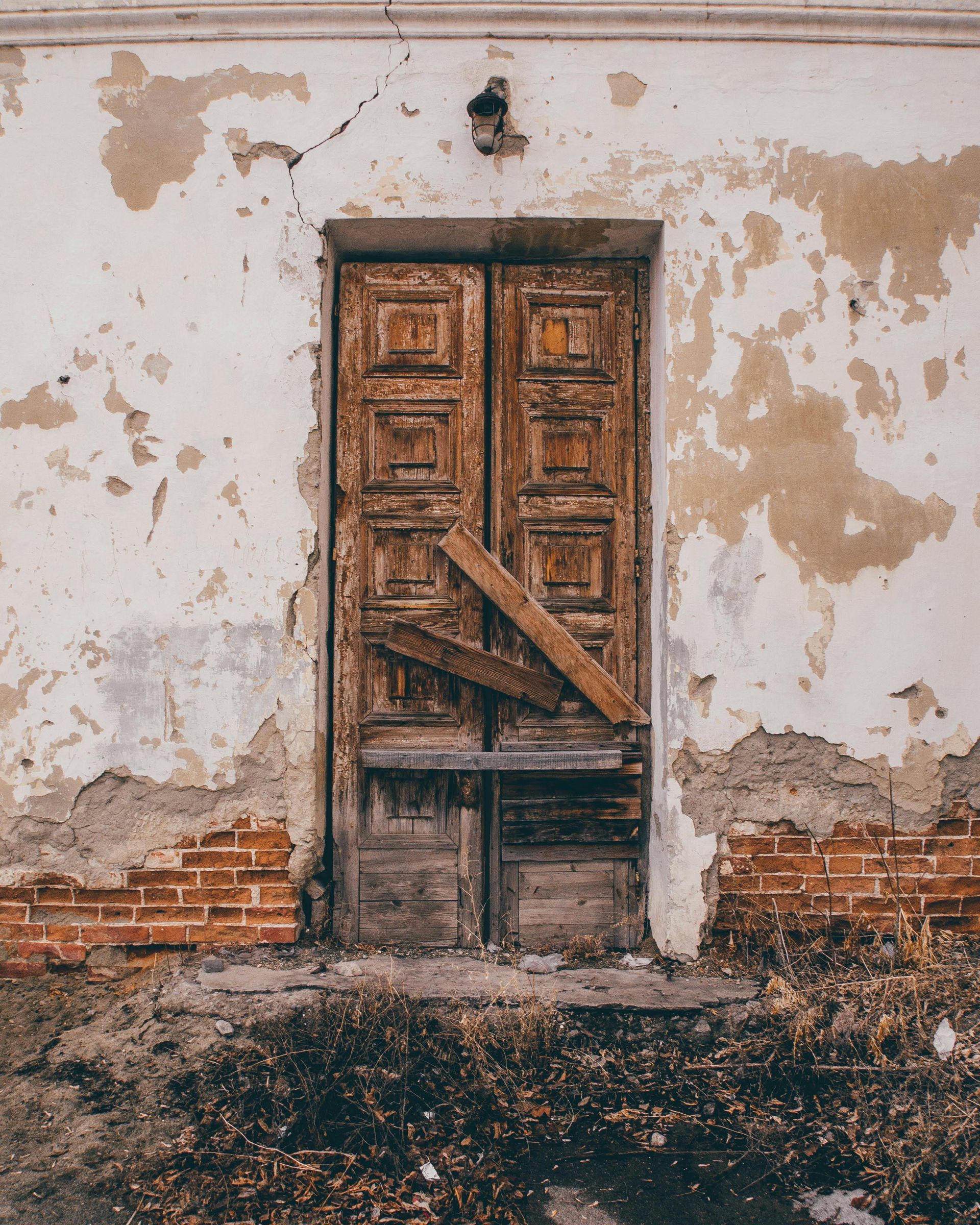 An old wooden door with a piece of wood sticking out of it