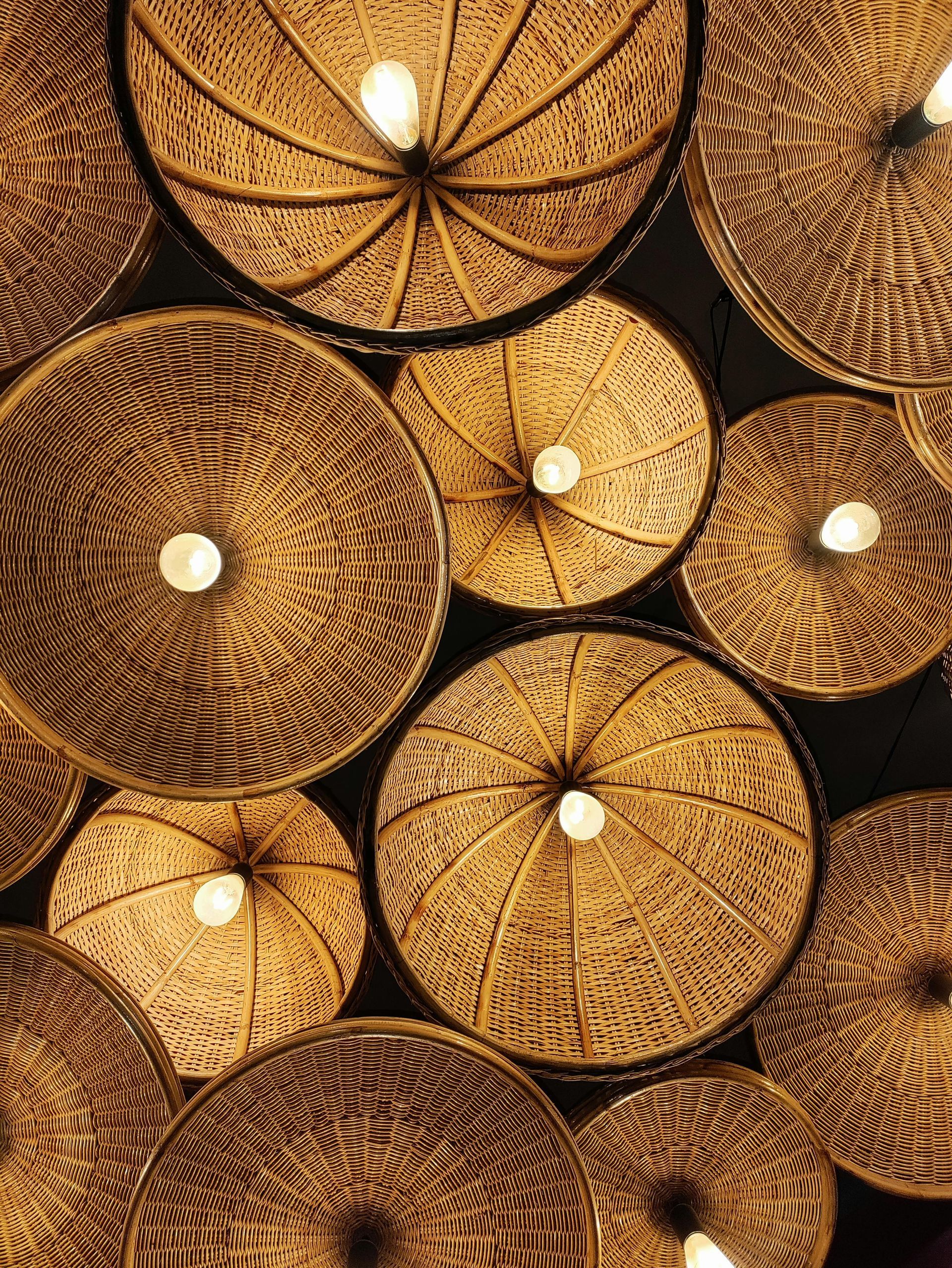 A bunch of wooden lamps are stacked on top of each other.