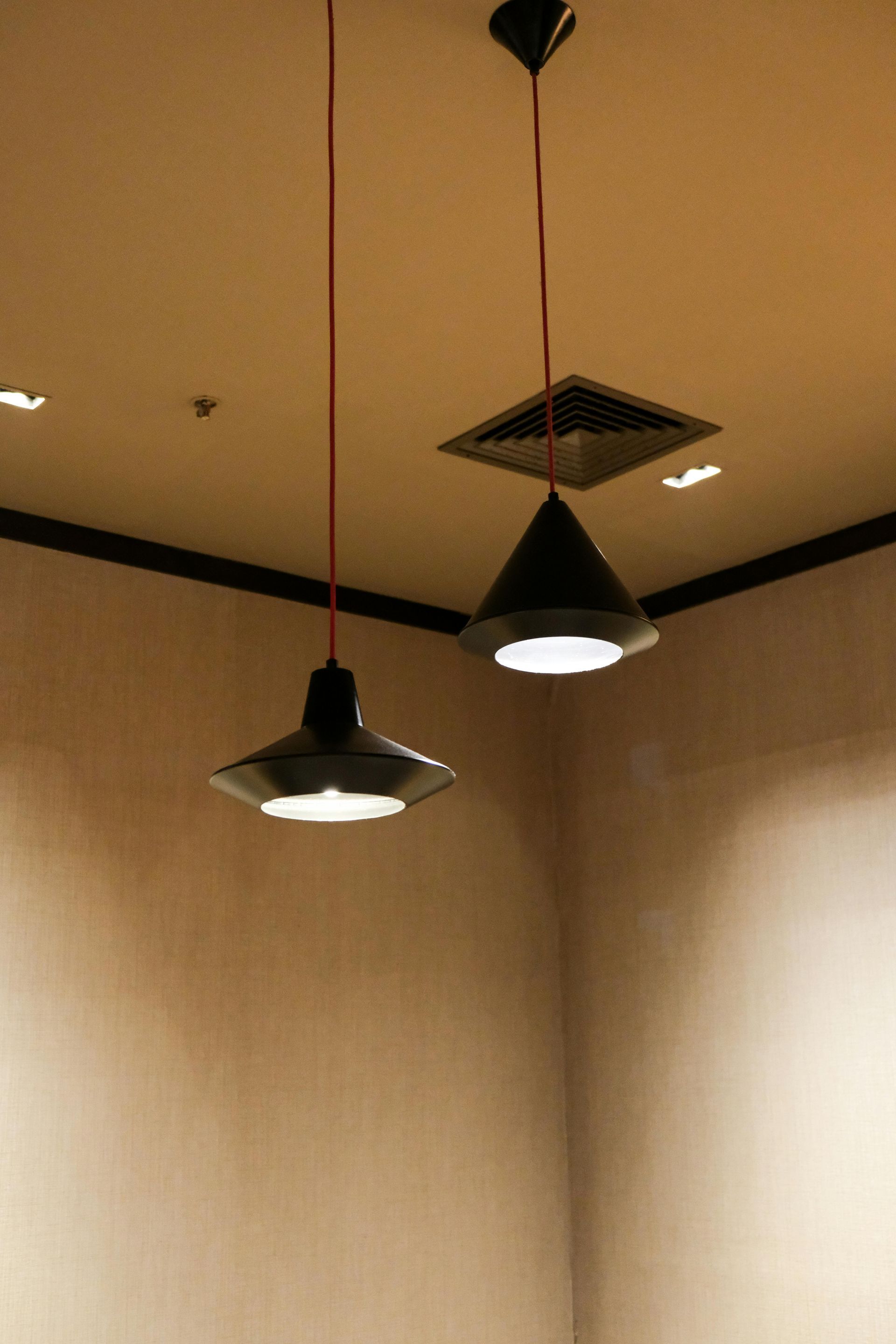 Three lights are hanging from the ceiling in a room