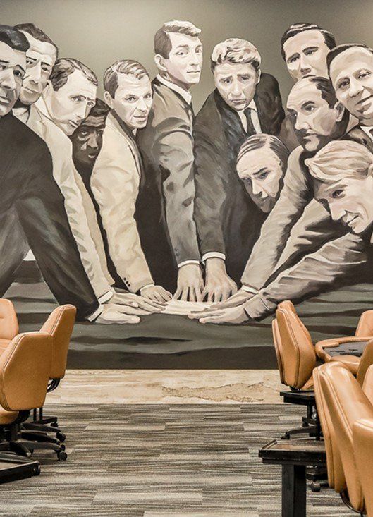 A mural containing a group of well suited men that resemble the rat pack