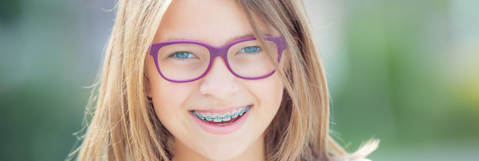 Young girl with braces smiling