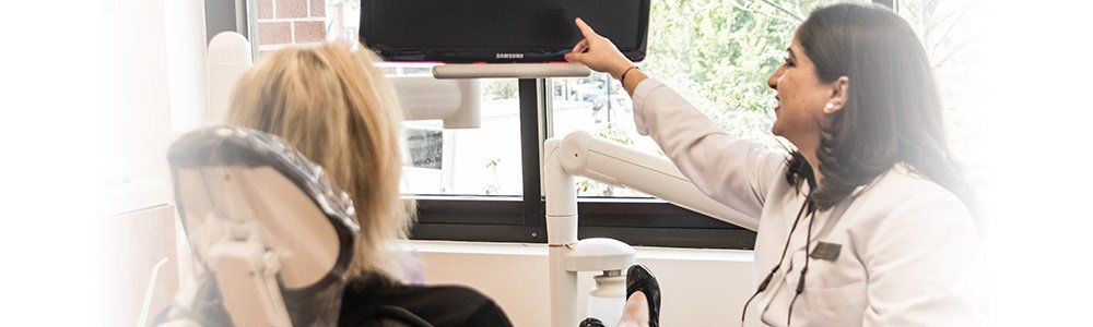 Dentist showing patient photos