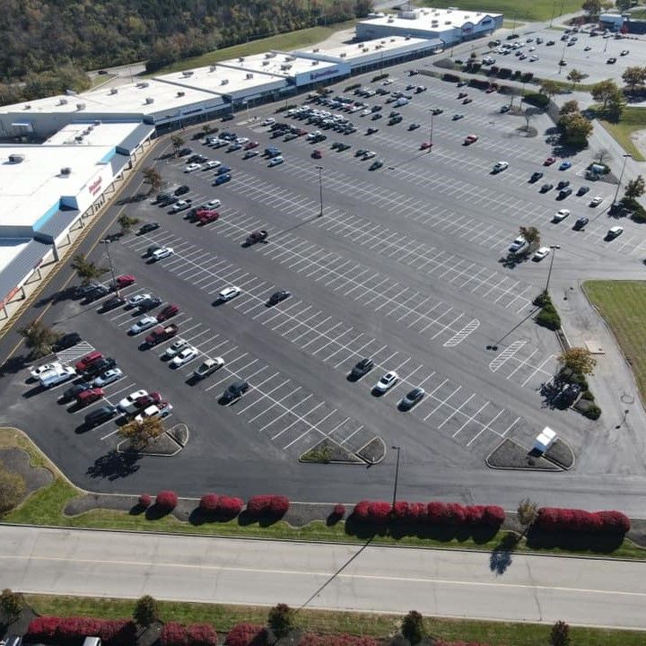 An aerial view of a parking lot filled with cars