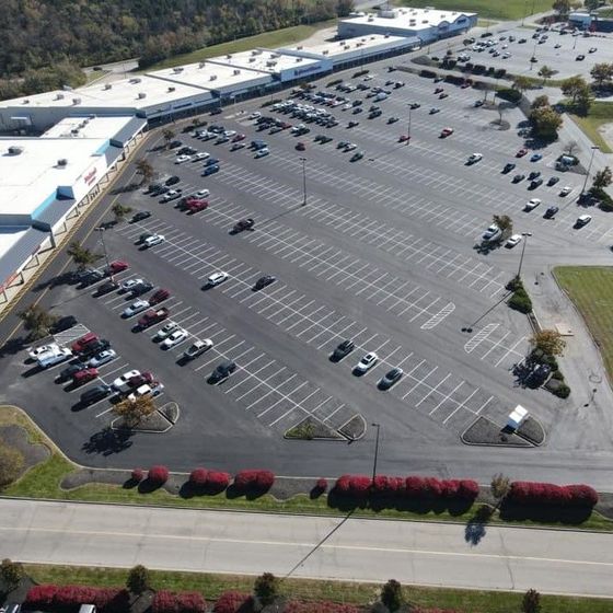 An aerial view of a parking lot filled with cars An aerial view of a parking lot filled with cars