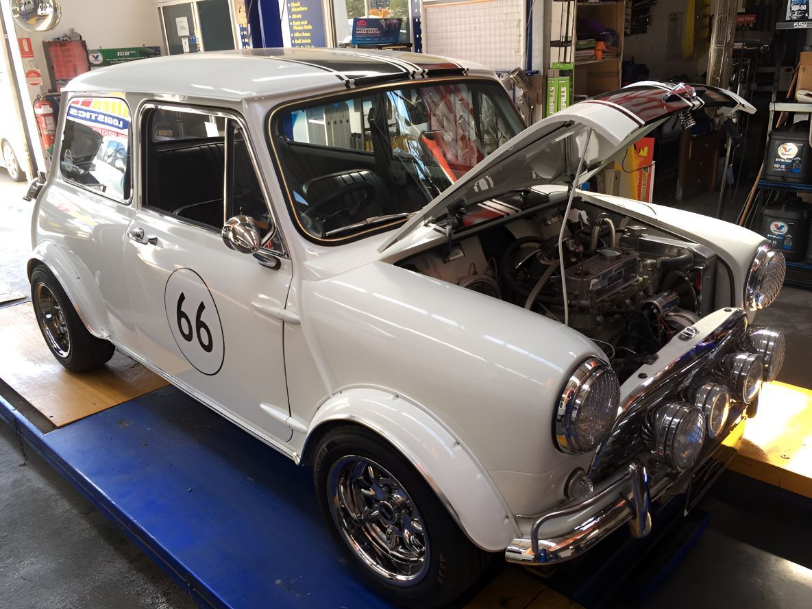 White Car With the 66 on the Side is Parked in a Garage — One Stop Service and Suspension Centre In Port Macquarie, NSW