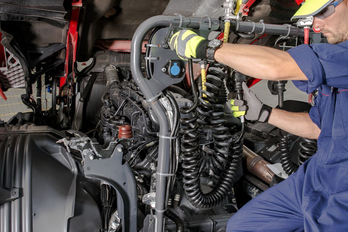 A Man is Working on the Engine of a Truck — One Stop Service and Suspension Centre In Port Macquarie, NSW