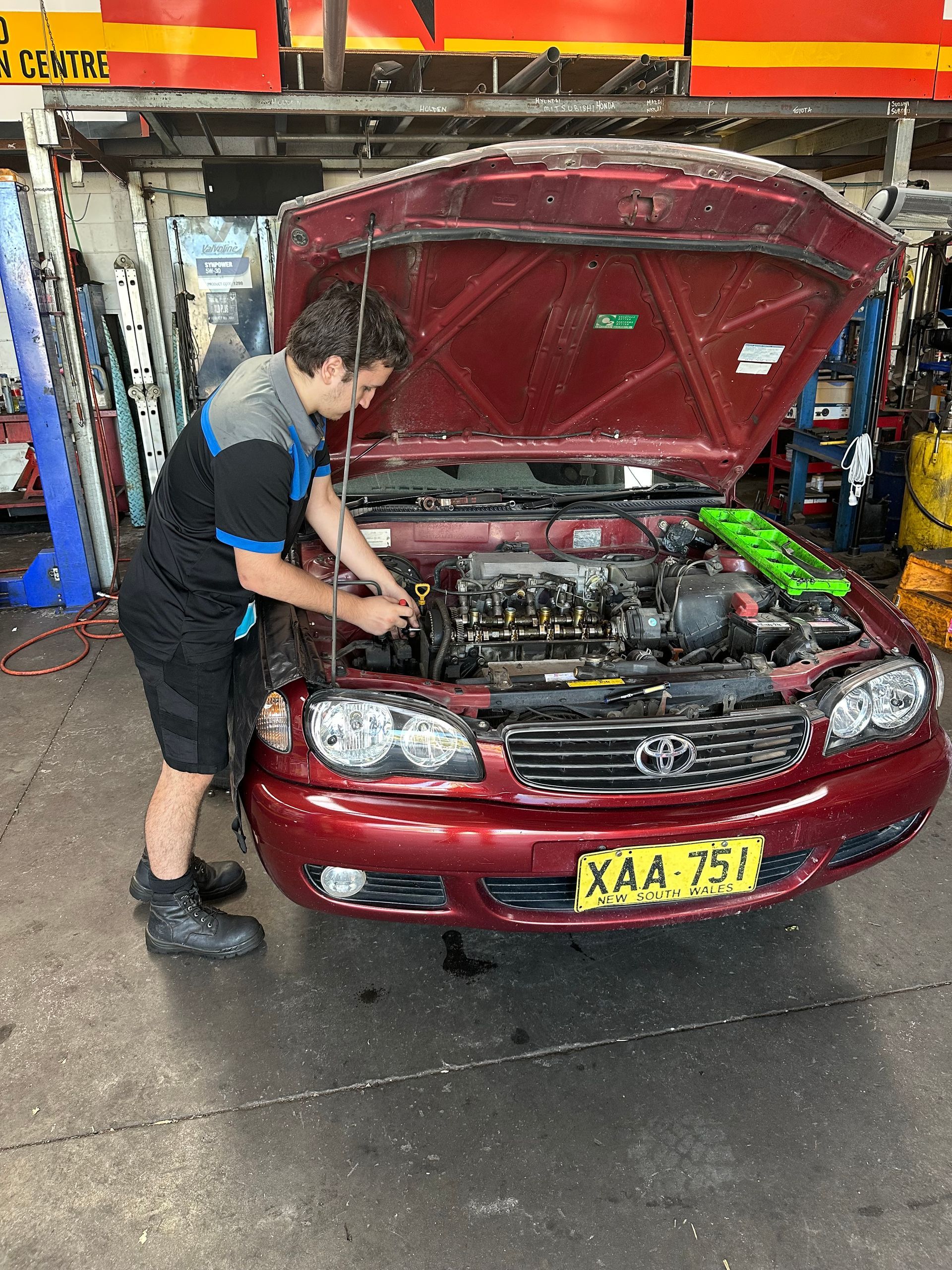 A man is working on a car in a garage. — One Stop Service and Suspension Centre In Port Macquarie, NSW