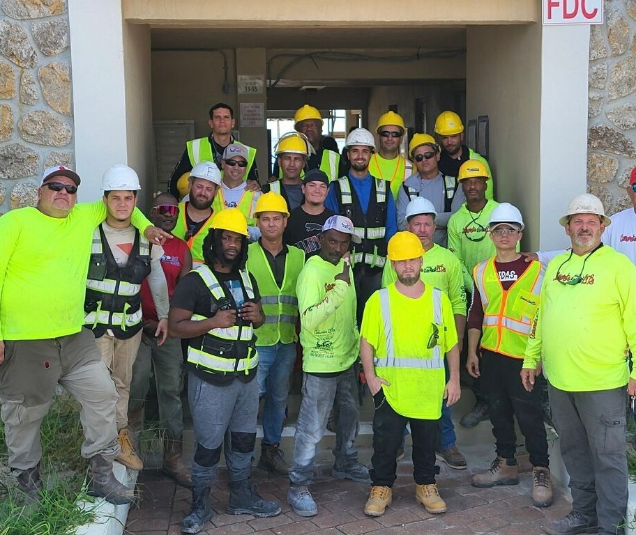 A group of construction workers are posing for a picture