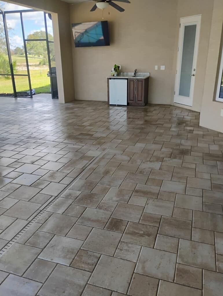 A large room with a tiled floor and a ceiling fan.