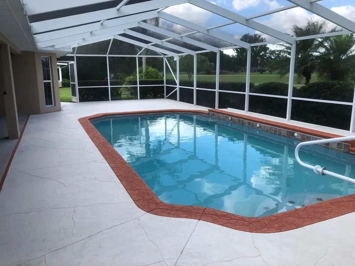 An indoor swimming pool with a screened in area