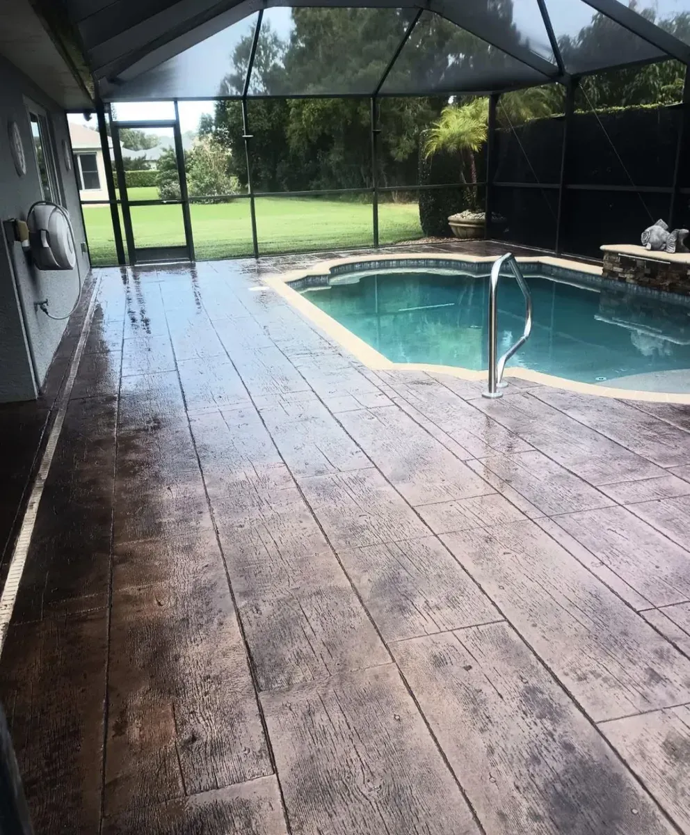 A swimming pool in a screened in area with a wooden floor