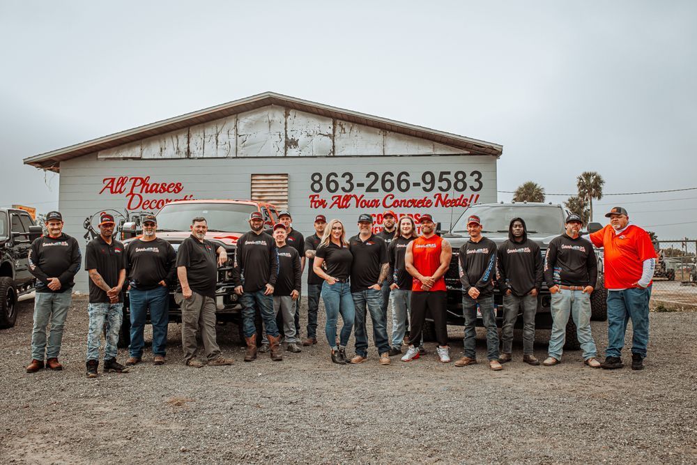 A group of men are posing for a picture in front of a building.